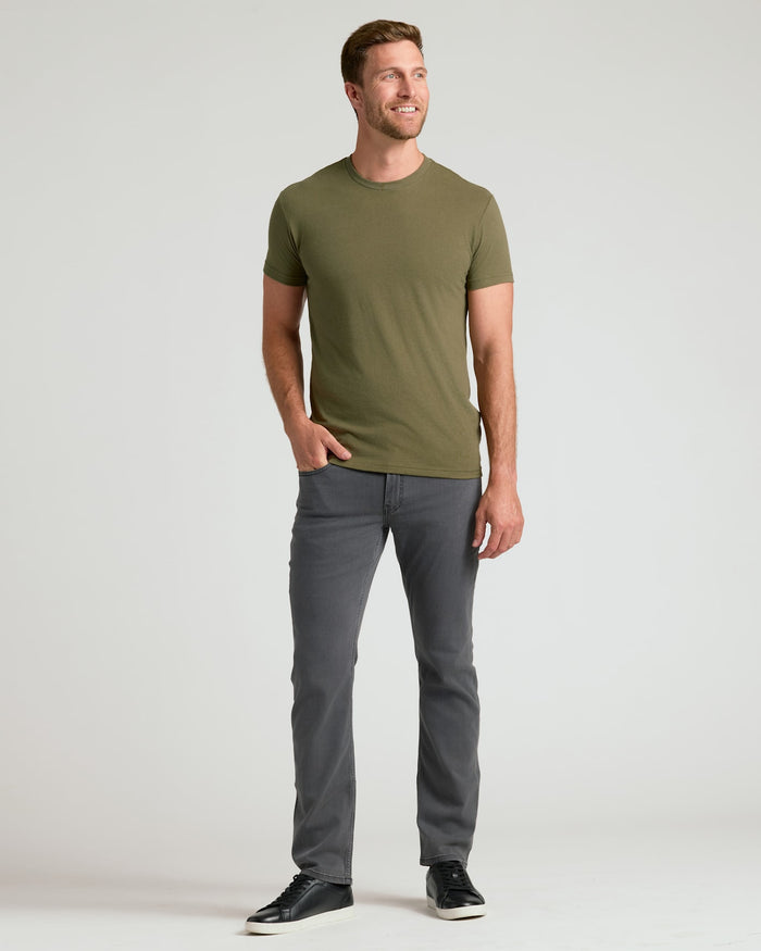 Man in Classic Crew Neck 6-Pack, olive tee, charcoal jeans.