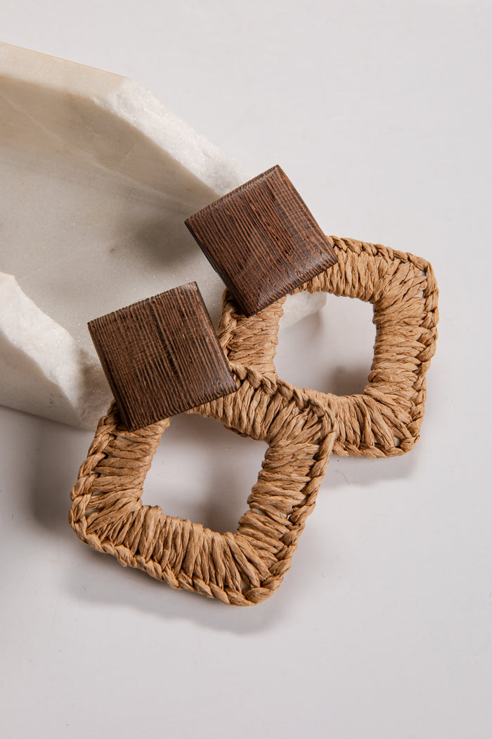 Brown woven earrings on a light background
