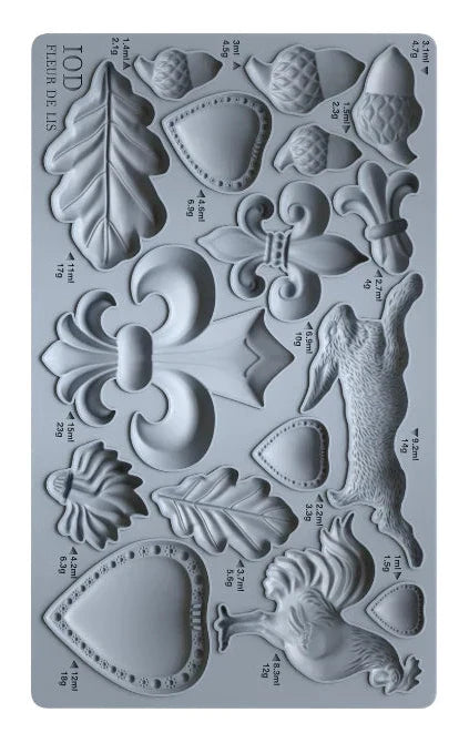 Decorative silicone mold with various shapes and measurements on a gray background