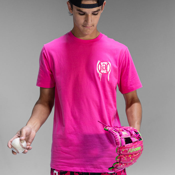 Person in pink t-shirt with a white BL101 logo with pink baseball and glove on a gray background