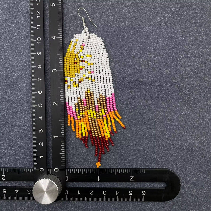 Hand-woven Sun Fringe Earrings by Mio Queena featuring vibrant, sun-inspired woven fringe and elegant dangle design.