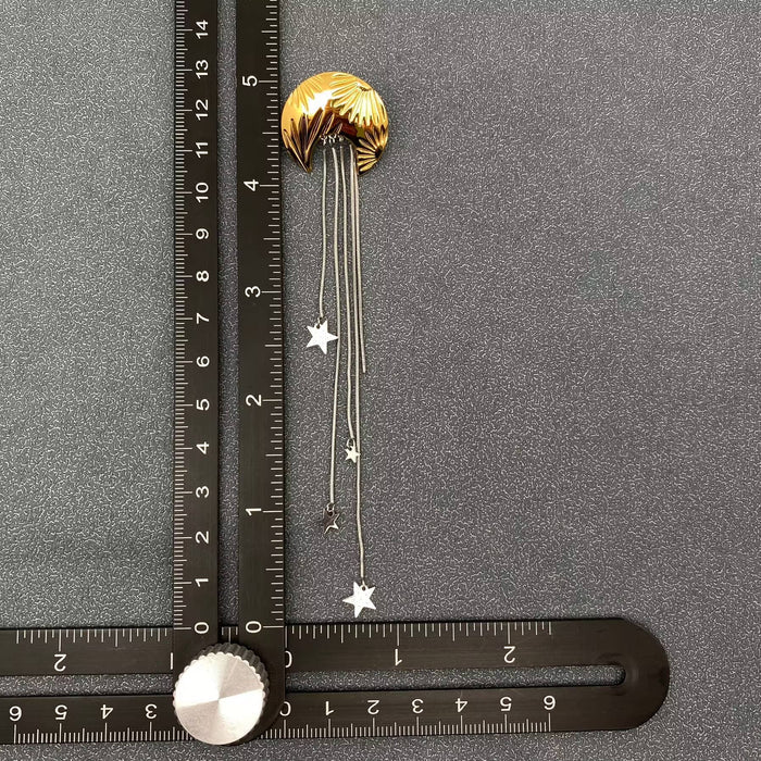 Star fringe moon earrings by Mio Queena featuring dangling moon and star charms with fringe detail in silver tone.