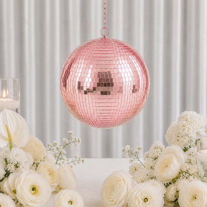 Pink mirrored disco ball centerpiece with white flowers and candles in elegant decor