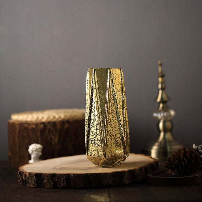 Gold geometric vase on wooden surface with decorative elements.