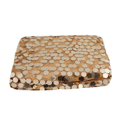 Gold sequin pillow on a plain background