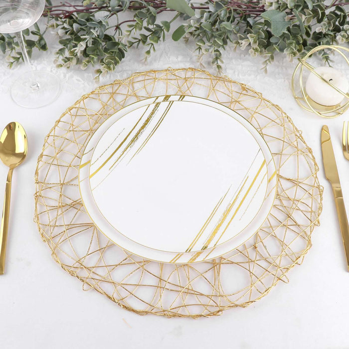 Gold-accented plate on decorative charger with elegant table setting.