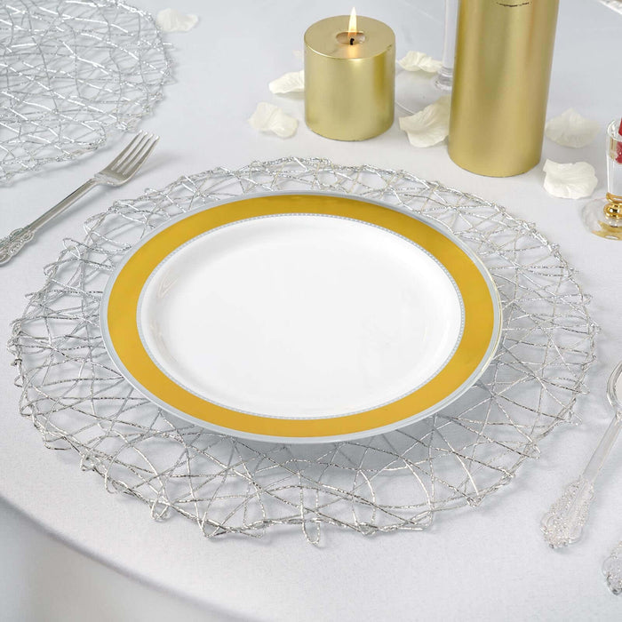 Elegant white plate with a gold rim on a decorative silver charger.