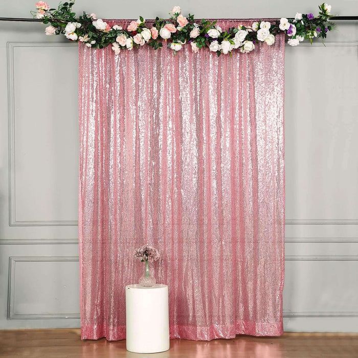 Sparkling pink sequin backdrop with floral decoration for events and photography.