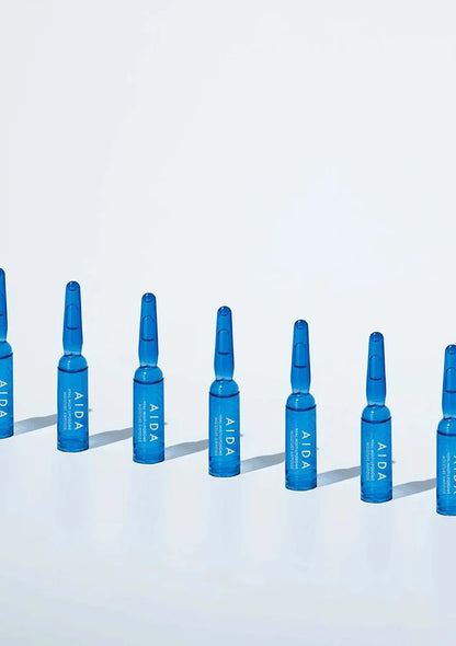 Blue AIDA ampoules arranged in a row on a light blue background
