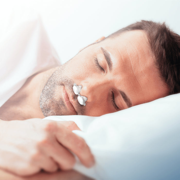 man sleeps on his side while wearing the bongo rx epap
