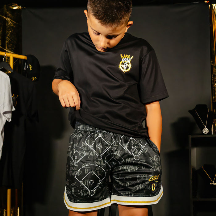 Youth model wearing black youth shorts with "Built For The Diamond" design