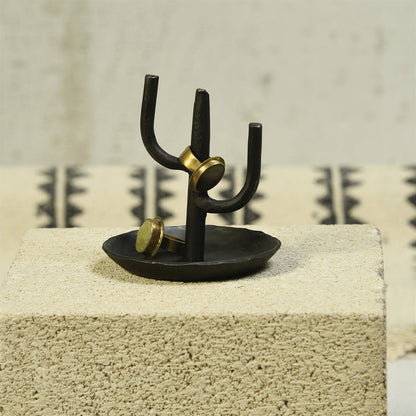 Black cactus ring holder with gold rings on three prongs