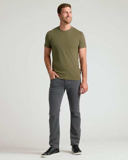 Man wearing Classic Crew Neck 6-Pack t-shirt and slim-fit jeans.