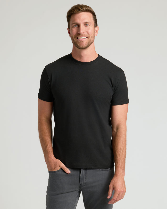 Man smiling in The Staple Classic Crew 10-Pack black T-shirt.