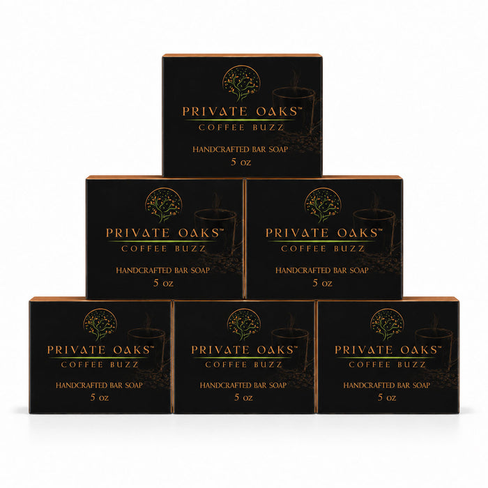 Six black boxes of Private Oaks Coffee Buzz Handcrafted Bar Soap arranged in a pyramid stack on a white background.