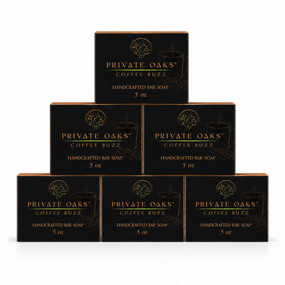 Six black boxes of Private Oaks Coffee Buzz Handcrafted Bar Soap arranged in a pyramid stack on a white background.