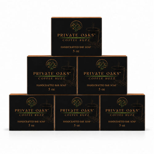 Six black boxes of Private Oaks Coffee Buzz Handcrafted Bar Soap arranged in a pyramid stack on a white background.
