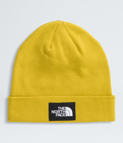 Yellow beanie with The North Face logo on a light gray background