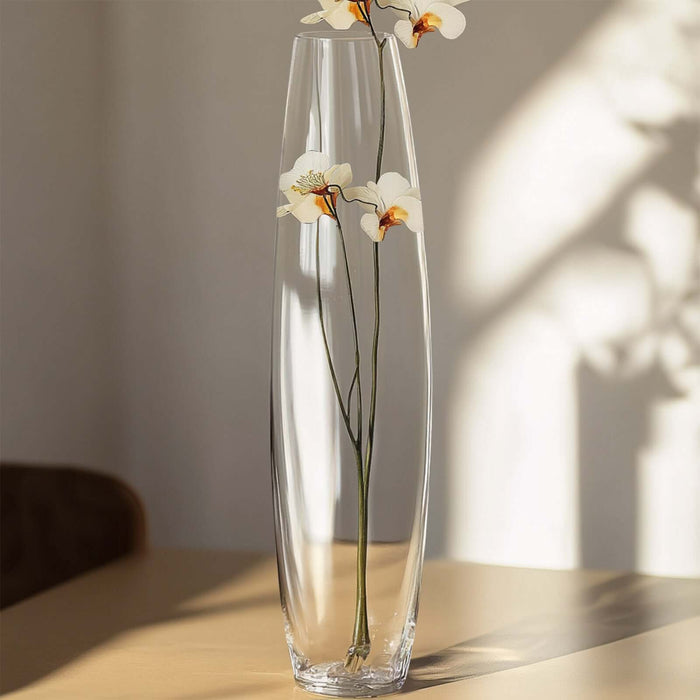 Tall crystal vase with white flowers, elegant home decor.