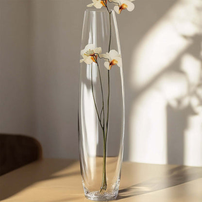 Tall crystal vase with white flowers, elegant home decor.