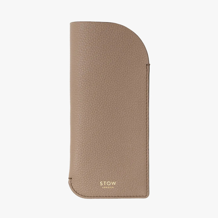 STOW London's Glasses Case in Taupe pebbled leather, featuring a gold logo on a light background