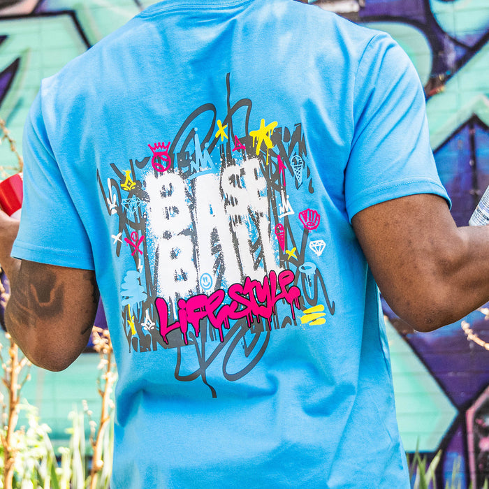 Adult model wearing blue graphic tee with “Graffiti Drip” design
