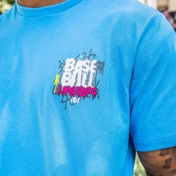 Adult model wearing blue graphic tee with “Graffiti Drip” design