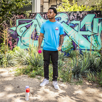 Adult model wearing blue graphic tee with “Graffiti Drip” design