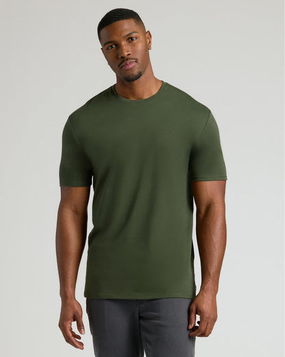 Man wearing an olive green crew neck t-shirt standing against a plain background, showcasing the Tall Pima Cotton Blend Crew 4-Pack men's basics.