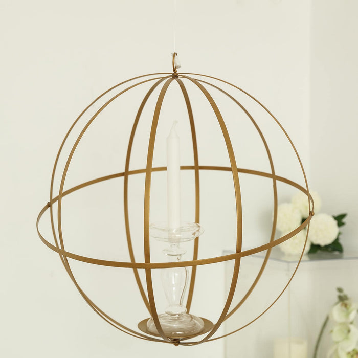 Gold spherical candle holder with a clear glass base and white candle inside.