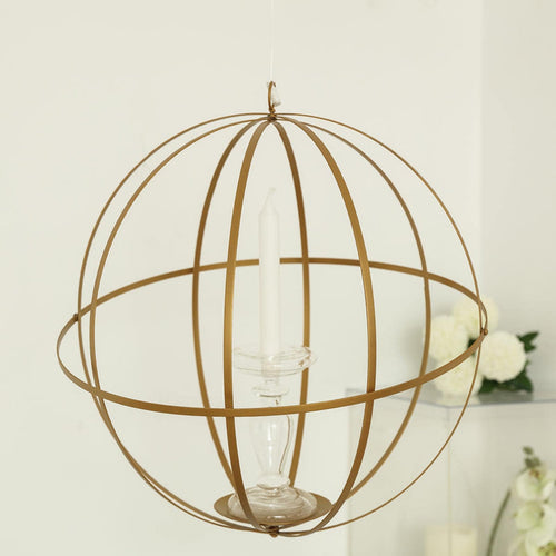 Gold spherical candle holder with a clear glass base and white candle inside.