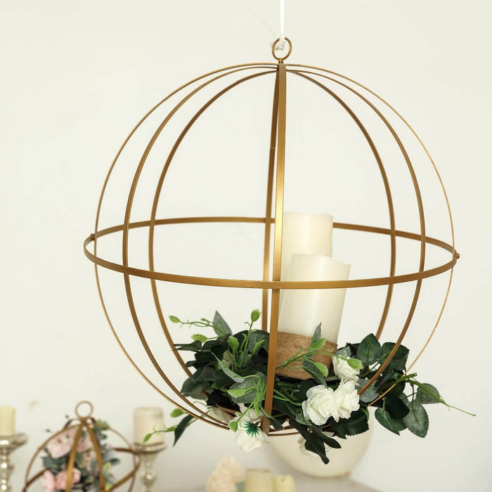 Gold globe pendant light with candles and greenery