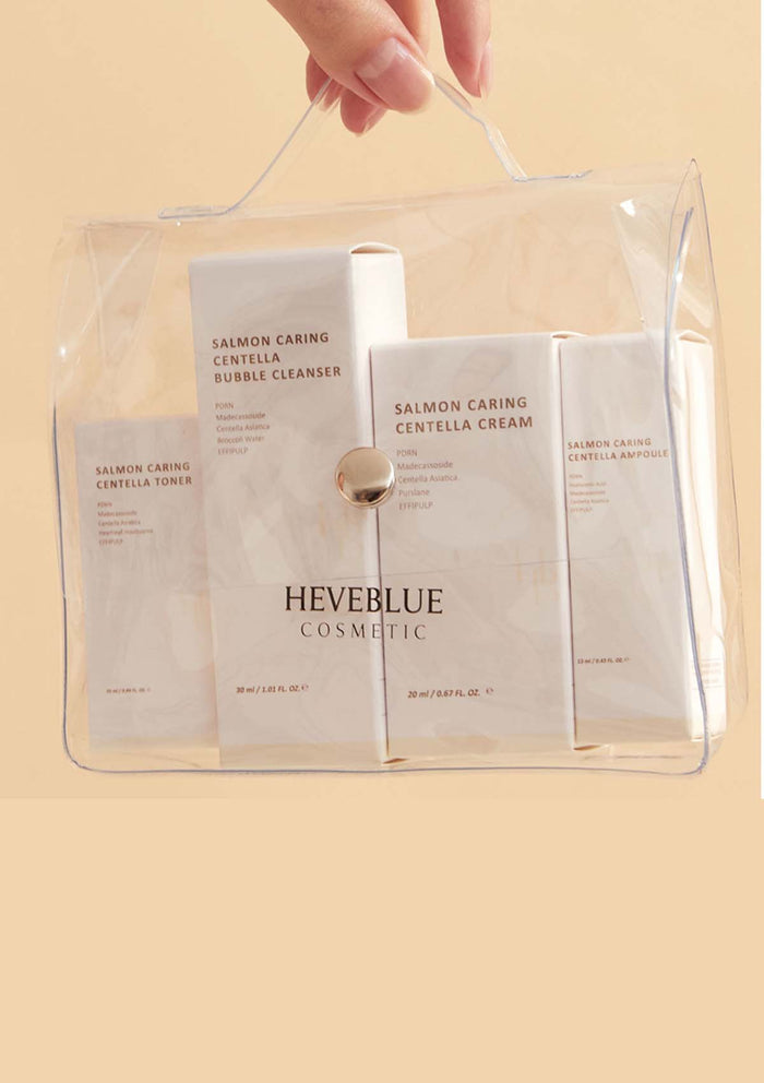 HEVEBLUE Salmon Caring Centella Special Travel Kit, including a bubble cleanser, toner, ampoule, and cream in a transparent plastic packaging with a handle.