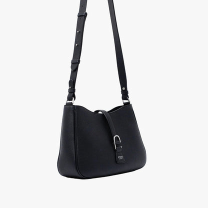 Off-axis view of STOW London's Beth bag and detachable crossbody strap in Black leather featuring silver stainless steel hardware on a white background