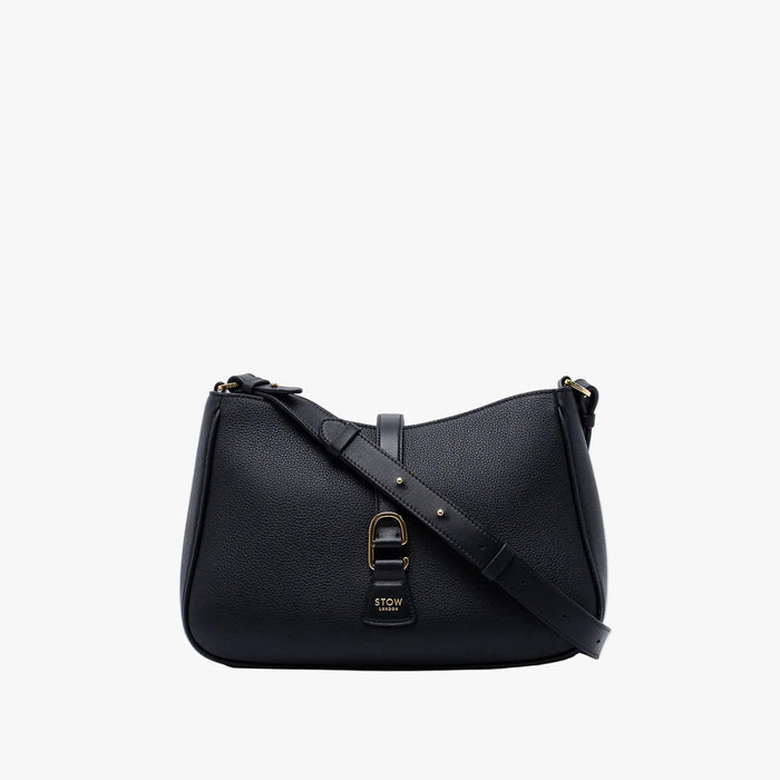 STOW London's Beth bag and detachable crossbody strap in Black leather featuring gold stainless steel hardware on a white background