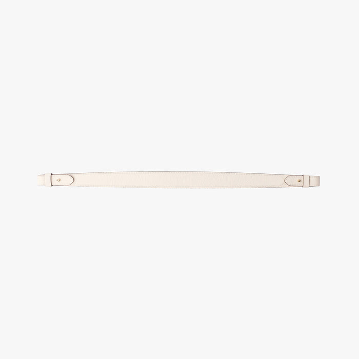 Detachable shoulder strap for STOW London's Curve, Midi Curve and East West in Spring Moon pebbled leather on a light grey background featuring gold hardware
