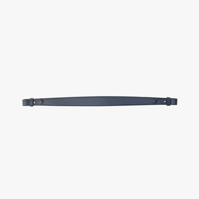Detachable shoulder strap for STOW London's Curve, Midi Curve and East West in Navy smooth leather on a light grey background featuring gold hardware