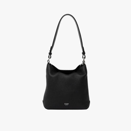 STOW London's Midi Curve and detachable shoulder strap in Black leather on a light grey background featuring silver hardware and details