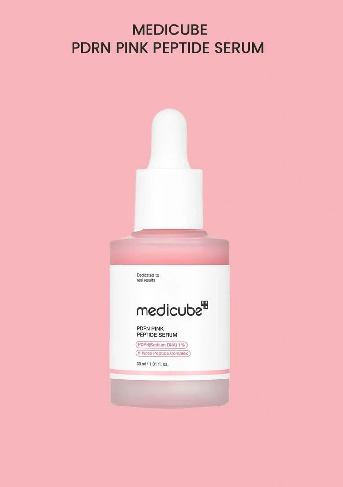 Medicube PDRN Pink Peptide Serum bottle on a pink background