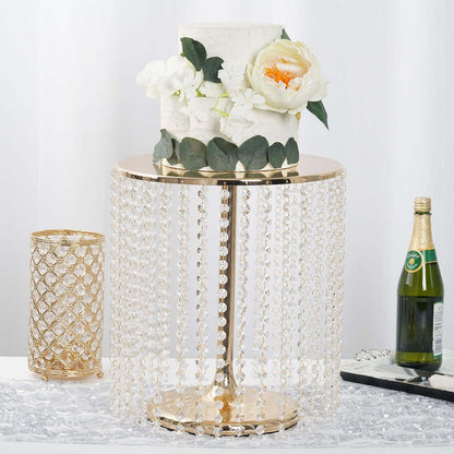 Elegant cake stand with crystal beads, adorned with flowers and a cake.
