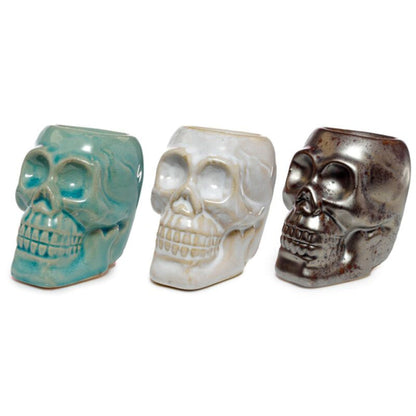 white brown and aqua mini ceramic skull oil burner variants displayed together