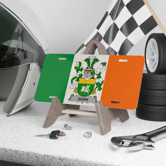 Quinn Irish Family Crest novelty license plate beside a car