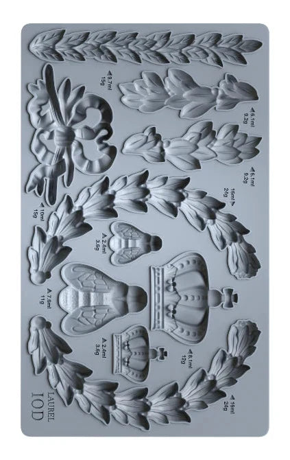 Silicone mold with floral and crown designs on a gray background