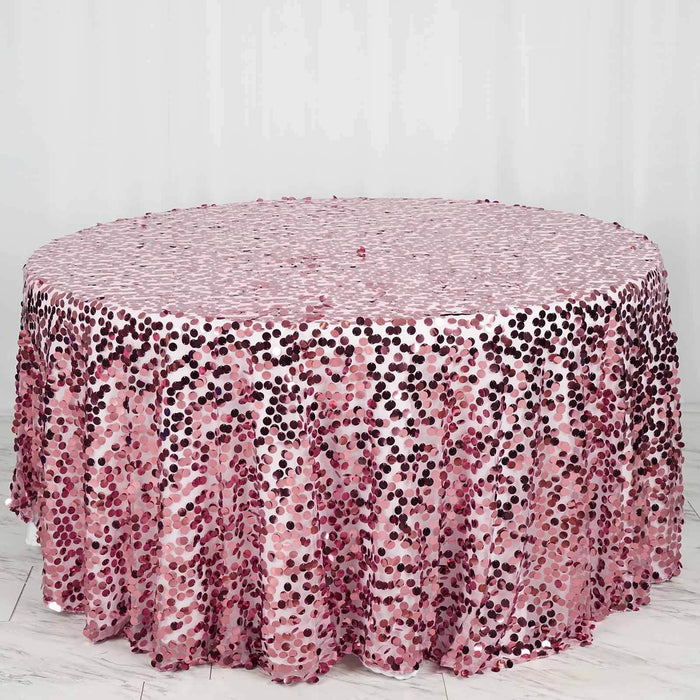Pink sequin tablecloth with a shimmering dotted pattern on a round table.