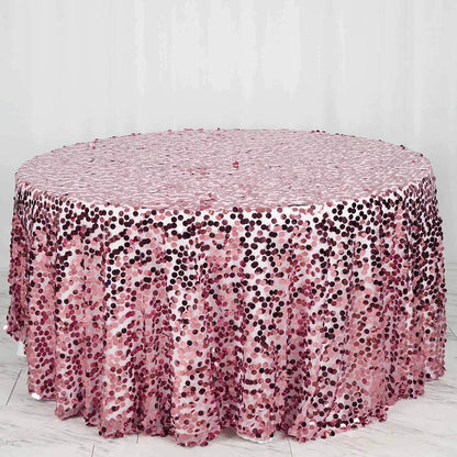 Pink sequin tablecloth with a shimmering dotted pattern on a round table.