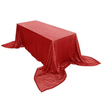 Red glitter tablecloth draped elegantly over a rectangular table