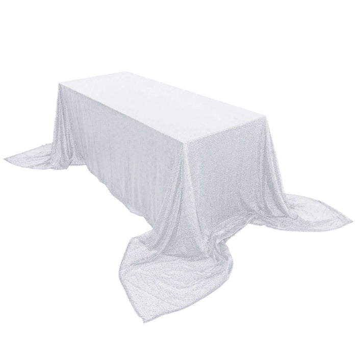Sparkling silver tablecloth draped over a rectangular table