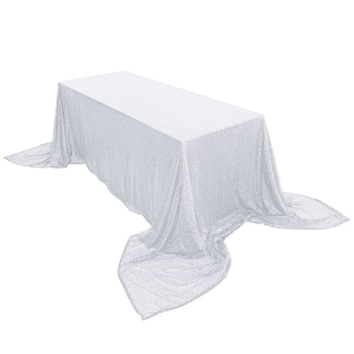 Sparkling silver tablecloth draped over a rectangular table