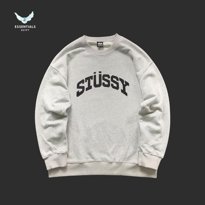 Gray Stussy sweatshirt on a black background