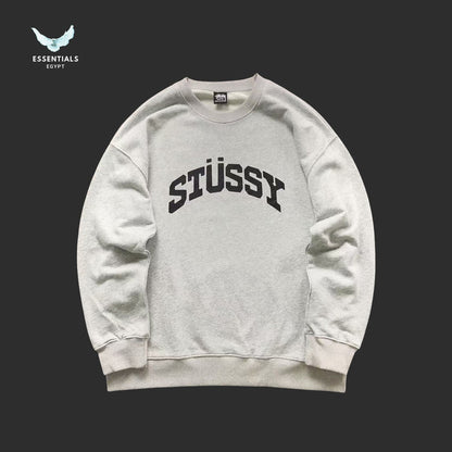 Gray Stussy sweatshirt on a black background